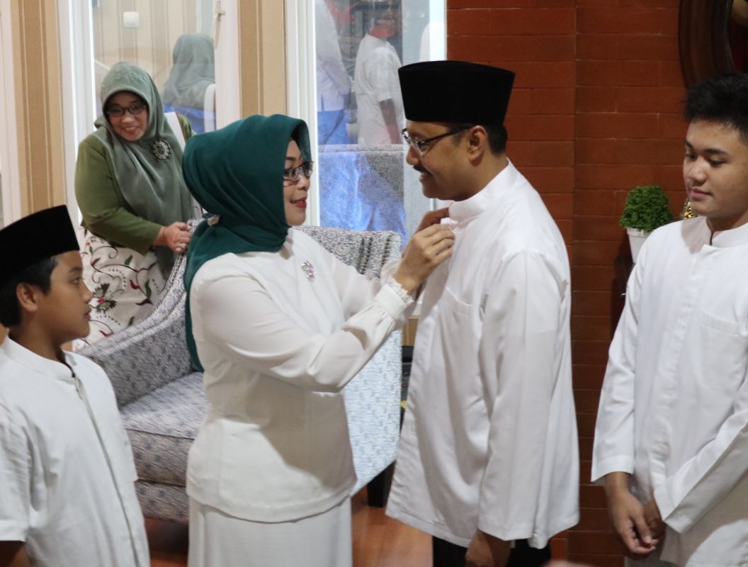 Istri Gus Ipul Fatma Saifullah Yusuf merapikan kancing baju koko Gus Ipul sebelum berangkat ke TPS 03 di Gayungan Surabaya. (Foto: istimewa)