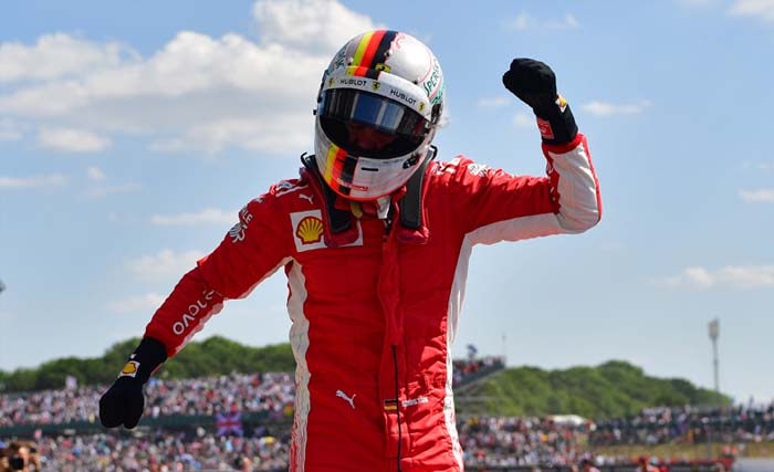Pembalap Ferrari Sebastian Vettel melakukan selebrasi setelah memenangkan GP F1 Silverstone di Inggris tengah, 8 Juli 2018. (foto: andrej isakovic/afp)