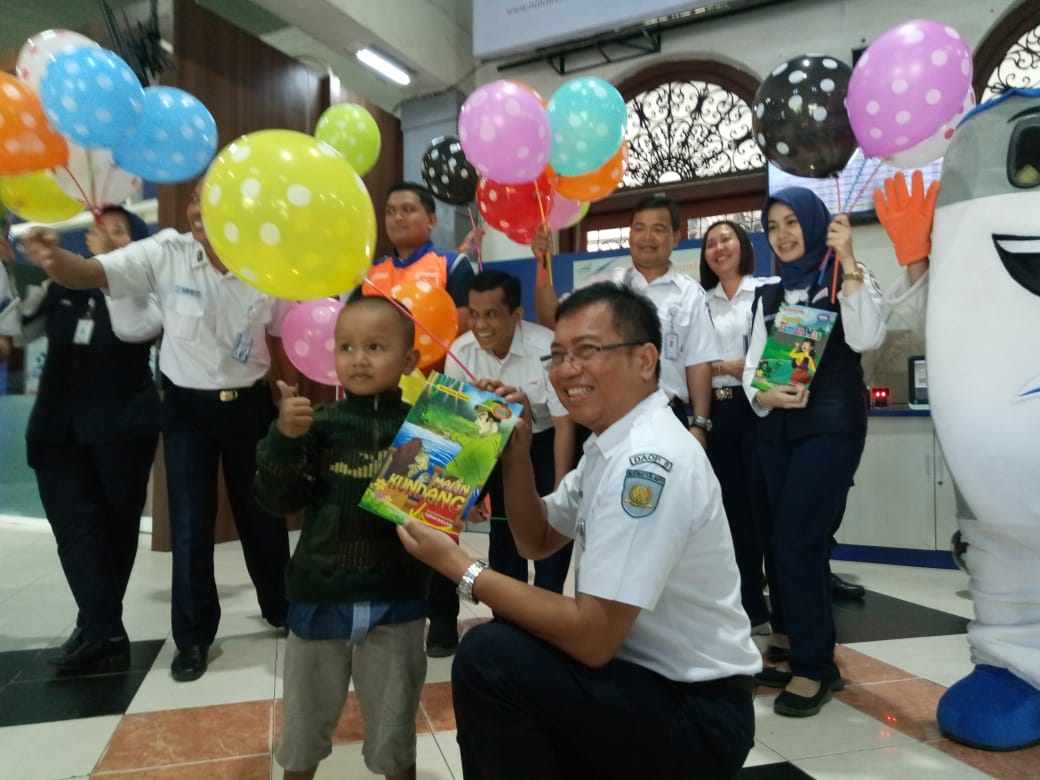 PT KAI DAOP 8 saat memberikan souvenir kepada penumpang anak-anak, di Stasiun Gubeng, Senin, 23 Juli 2018. (Foto: Farid/ngopibareng.id) 