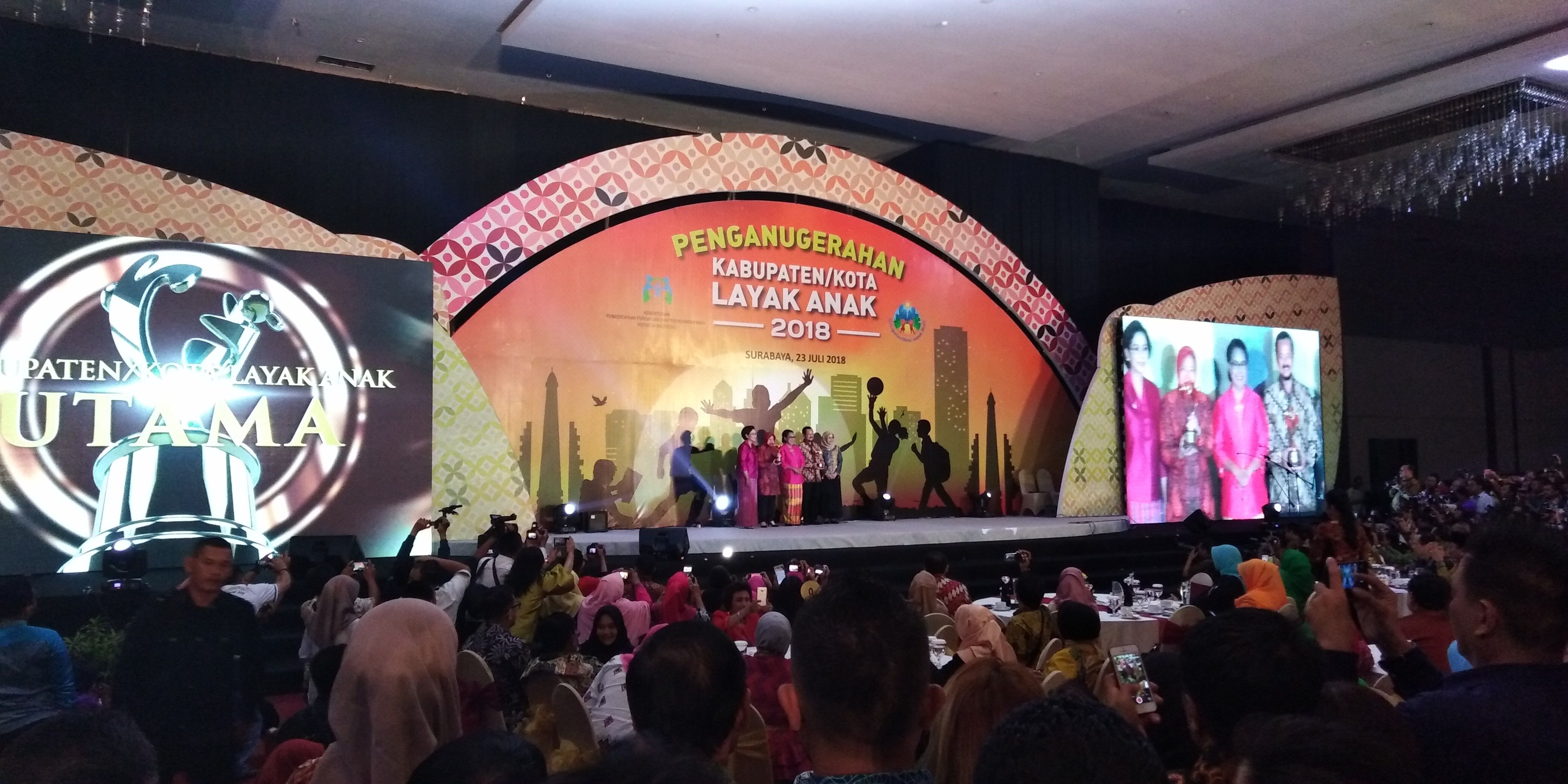 Wali Kota Surabaya Tri Rismaharini mewakili Surabaya menerima penghargaan Kota Layak Anak dari Kementrian Pemberdayaan Perempuan dan Perlindungan Anak (KPPPA) untuk kategori Utama sebagai Kota Layak Anak (KLA), di Dyandra Convention Center, Surabaya, Senin 23 Juli 2018, malam. (Foto: farid/ngopibareng.id) 