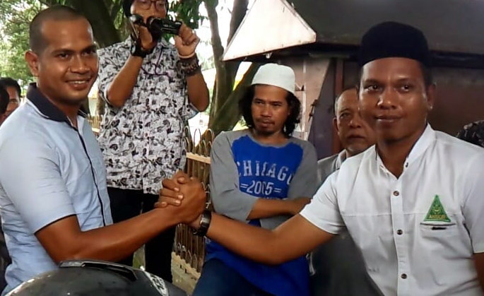 Perwakilan Pemuda Langkat dan GP Ansor berjabatan tangan paska kisruh pembubaran acara Kirab Satu Negeri, di Langkat. (Foto: Medan Merdeka)