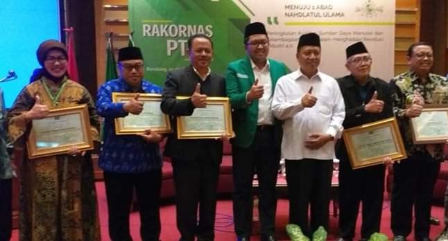 Prof. Achmad Jazidie  bersama PTNU lainnya saat menerima penghargaan pada rakernas yang diadakan di Bandung.  (Foto:istimewa)