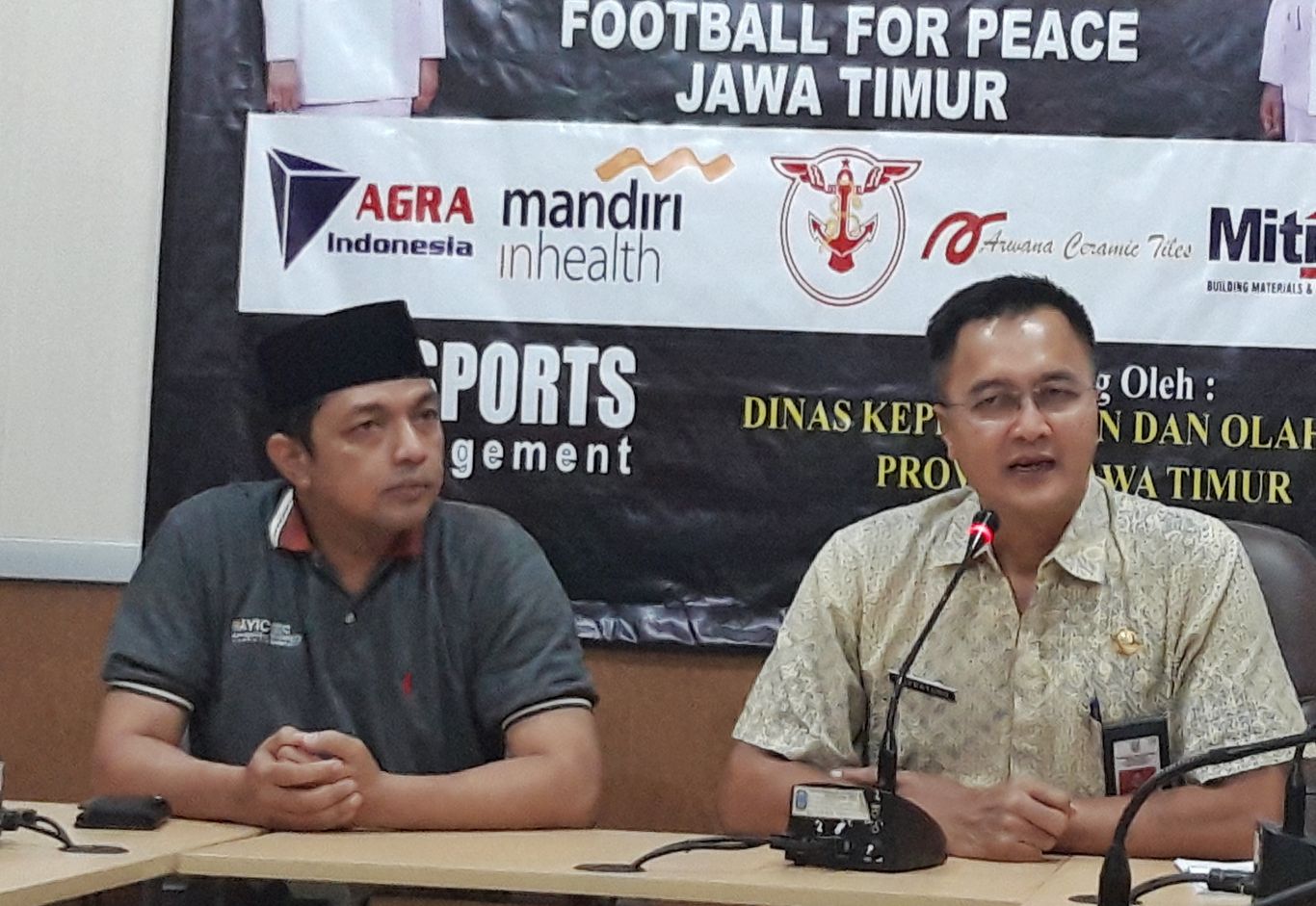 Ketua panitia Football for Peace, Gus Hans bersama Kadispora Surabaya, Soepratomo dalam konferensi pers, Jumat, 15 Maret 2019. (Foto: Haris/ngopibareng.id)