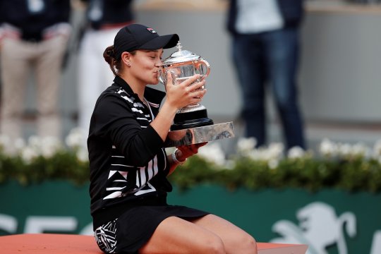 Petenis Australia Asleigh Barty mencium trofi French Open 2019 yang diraihnya usai menundukkan wakil Republik Ceko Marketa Vondrousova, Sabtu 8 Juni 2019. (Foto: Reuters/Antara)