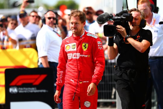 Pebalap Ferrari Sebastian Vettel berjalan di parc ferme usai finis runner-up di GP Kanada, Minggu 9 Juni 2019. (Foto: AFP/Reuters)