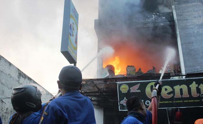 Petugas Damkar Kabupaten Cianjur, Jawa Barat berupaya memadamkan api yang membakar sebuah ruko di Pasar Baru, Cianjur hari Selasa dini hari. (Foto:Firman/kompas.com)