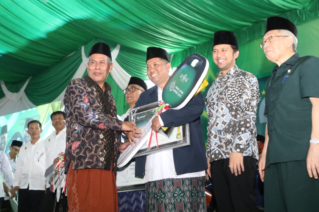 Ketua PWNU Jatim, KH Marzuki Mustamar (Kiri) memberi penghargaan kepada pemenang, disaksikan Wagub Jatim Emil Elestianto Dardak. (Foto: Faiq/ngopibareng.id)