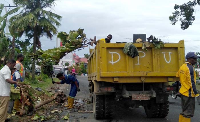 Petugas kebersihan membersihkan puing dan sampah yang berserakan di jalanan Kota Manokwari, kemarin. (Foto: Antara)