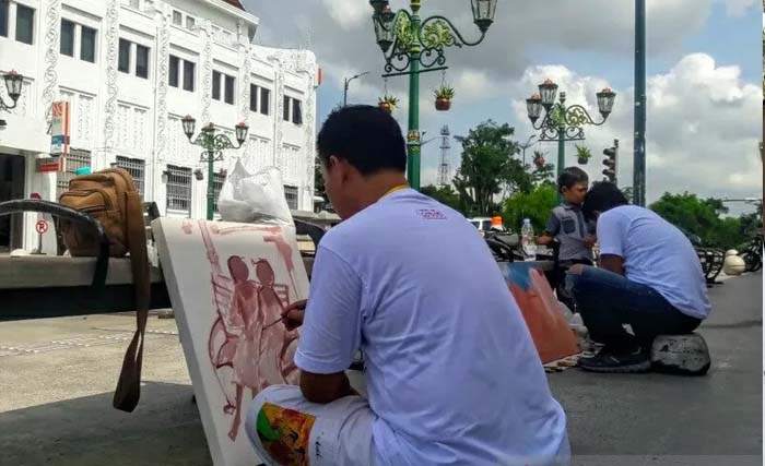 Sebagian perupa yang melukis bersama di Jalan Malioboro, Yogyakarta, Selasa. (Foto:Antara)