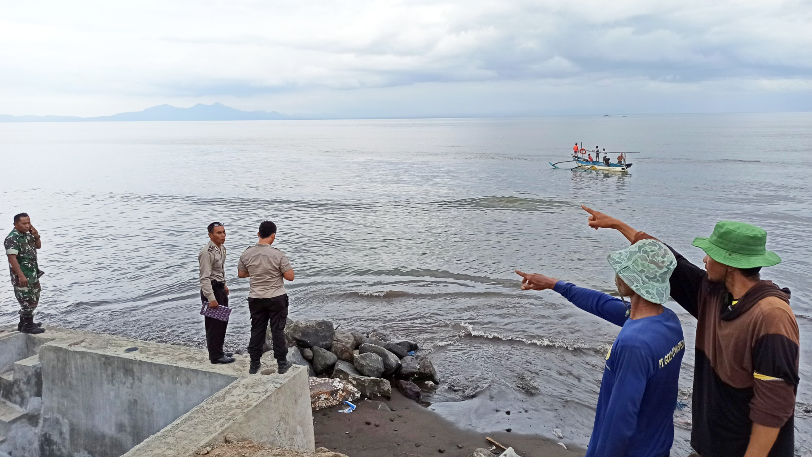Warga menunjukkan lokasi korban tenggelam. Tampak perahu nelayan sedang melakukan penyisiran (Foto : Muhammad Hujaini/Ngopibareng.id)
