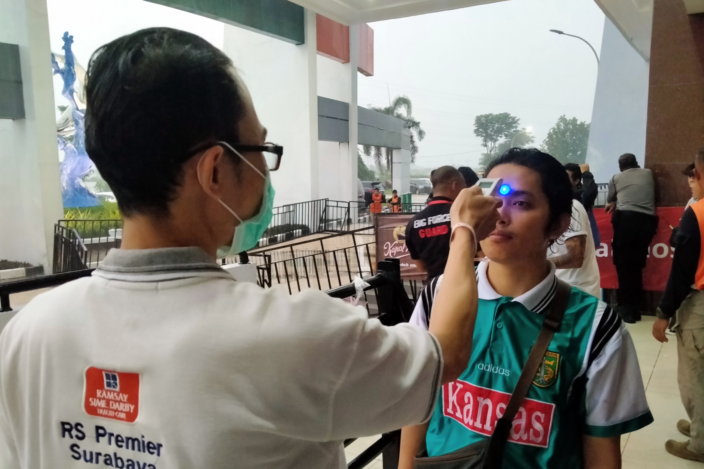 Tim kesehatan saat memeriksa suhu tubuh salah satu suporter di Stadion Gelora Bung Tomo (GBT), Surabaya, Jumat 13 Maret 2020. (Foto: Fariz Yarbo/Ngopibareng.id)