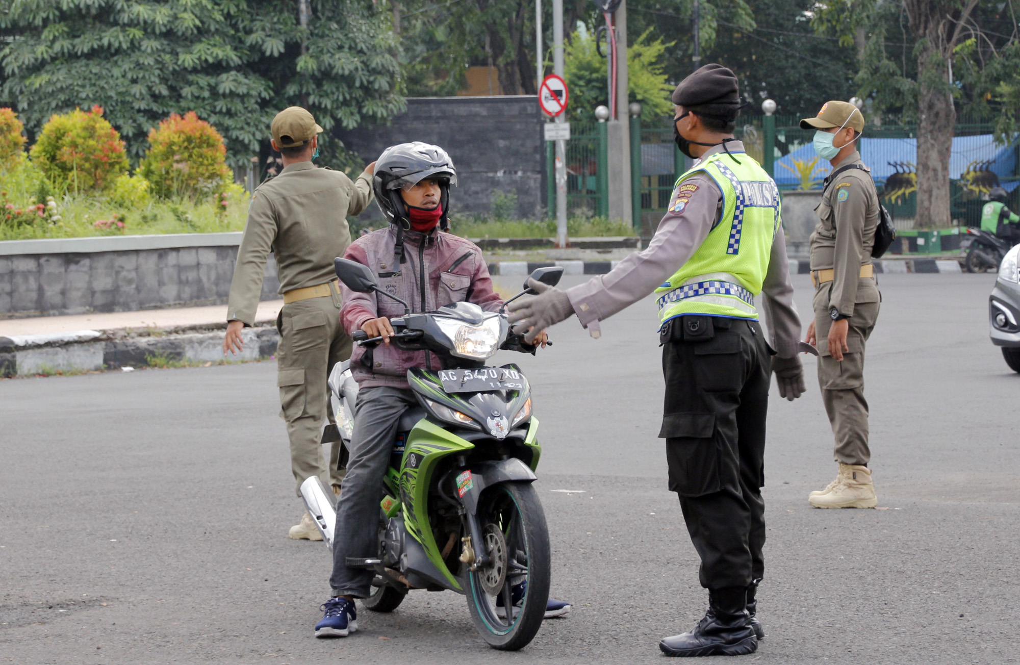 Anggota kepolisian melakukan pengecekan terhadap warga yang melintas di kawasan Jalan Pahlawan, Sidoarjo. (Foto: Fariz Yarbo/Ngopibareng.id)