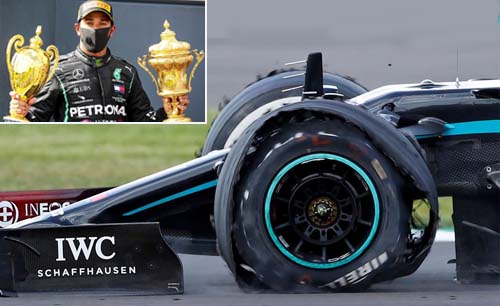 Dengan ban depan pecah, Lewis Hamilton masuk finis di Grand Prix Britania, Minggu. Hamilton dengan trofinya (inzet). (Foto:Reuters/Ngopibareng)