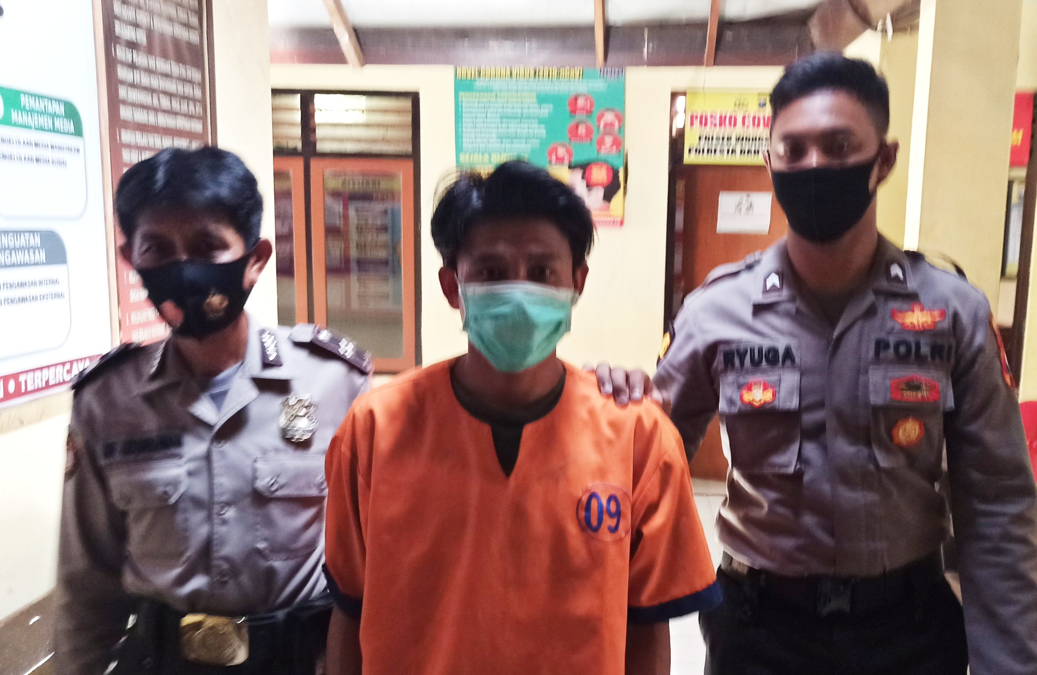 Tersangka kasus dugaan persetubuhan dengan anak dibawah umur, Tolak, dikawal petugas Kepolisian (foto:Muh Hujaini/ngopibareng.id)