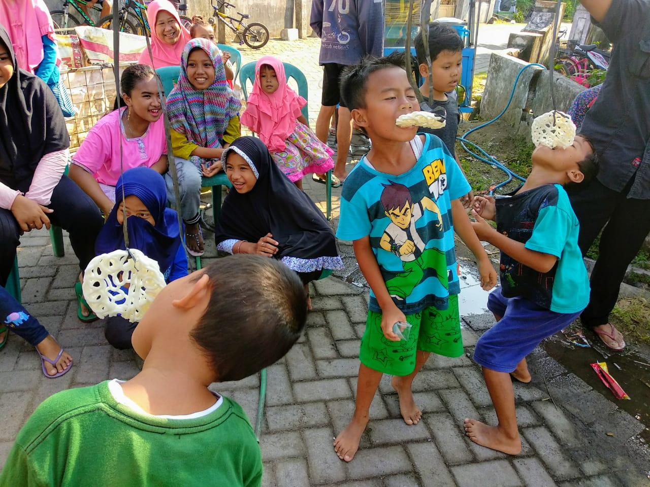 Tiga orang anak laki-laki mengikuti lomba makan kerupuk di Dusun Laban, Desa Bendet, Kecamatan Diwek, Kabupaten Jombang, Jawa Timur, Senin, 17 Agustus 2020. (Foto: M.Rizqi/Ngopibareng.id)