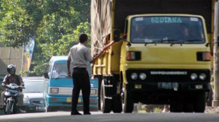 Ilustrasi petugas menerima upeti dari sopir truk. (Foto: Pos Kupang) 