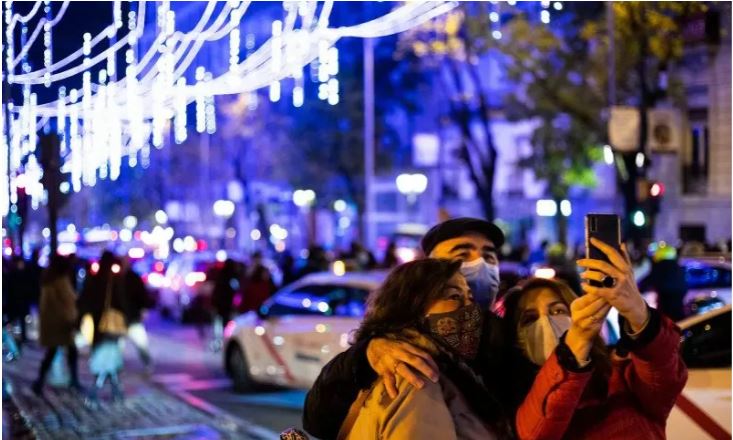  Warga berswafoto di sebuah jalan yang didekorasi dengan lampu-lampu hias di Madrid, ibu kota Spanyol, Sabtu 28 November 2020. Lampu-lampu hias untuk menyemarakkan perayaan Natal itu dipasang mulai 26 November 2020 hingga 6 Januari 2021. (Foto: Antara/Xinhua/Meng Dingbo)