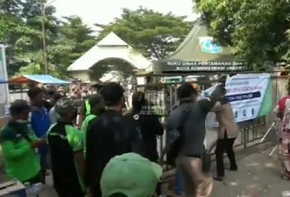 Warga merangsek ke pintu masuk TPU Tegal Alur Jakarta Barat setelah adu mulut dengan putugas. (Foto: Istimewa)