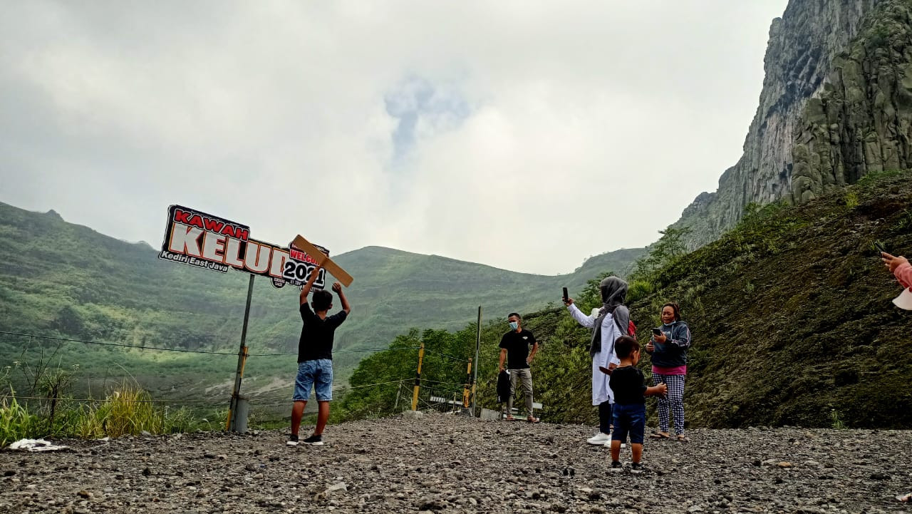 Para wisatawan Gunung Kelud mengabadikan potret bersama keluarganya. (Foto: Fendhy Plesmana/Ngopibareng.id)