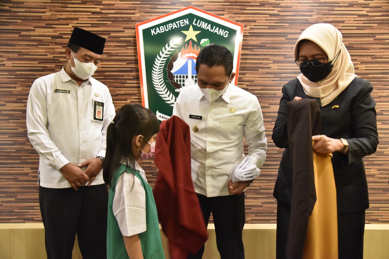 Bupati Lumajang, Wakil Bupati Lumajang dan Kepala Dinas Pendidikan Lumajang memberikan seragam gratis secara simbolis (Foto : Humas - Kominfo Lumajang)