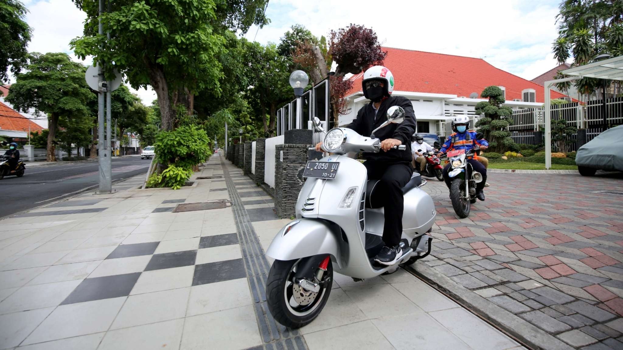 Walikota Surabaya, Eri Cahyadi, saat menggunakan vespanya ketika melakukan kunjungan kerja.