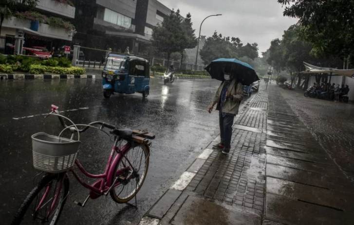 Warga berjalan menggunakan payung saat hujan di kawasan Kelurahan Gambir, Jakarta, Kamis, 16 Desember 2021. (Foto: Antara/Aprillio Akbar)