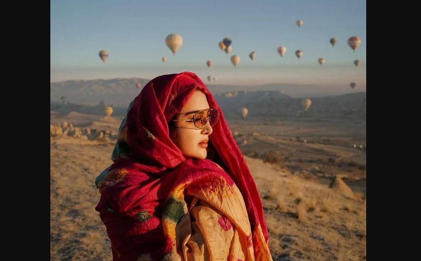 Ashanty berfoto dengan latar belakang balon udara yang memenuhi langit pagi Cappadocia. (Foto: Instagram)