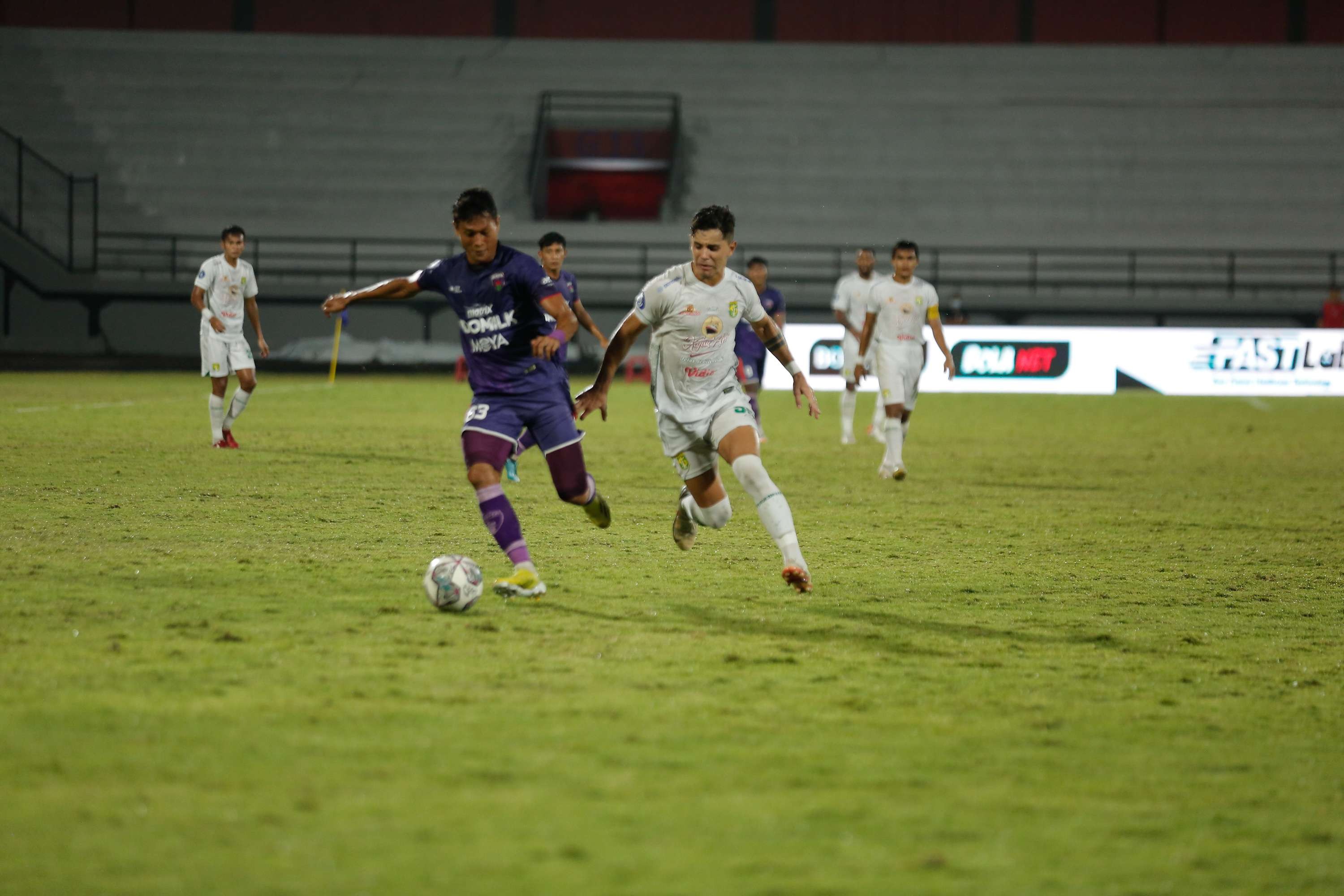 Pemain Persita Tangerang, Dedi Gusmawan menjaga ketat pergerakan pemain Persebaya Bruno Moreira dalam laga di Stadion Kapten I Wayan Dipta, Bali, Minggu 6 Maret 2022. (Foto: Istimewa)