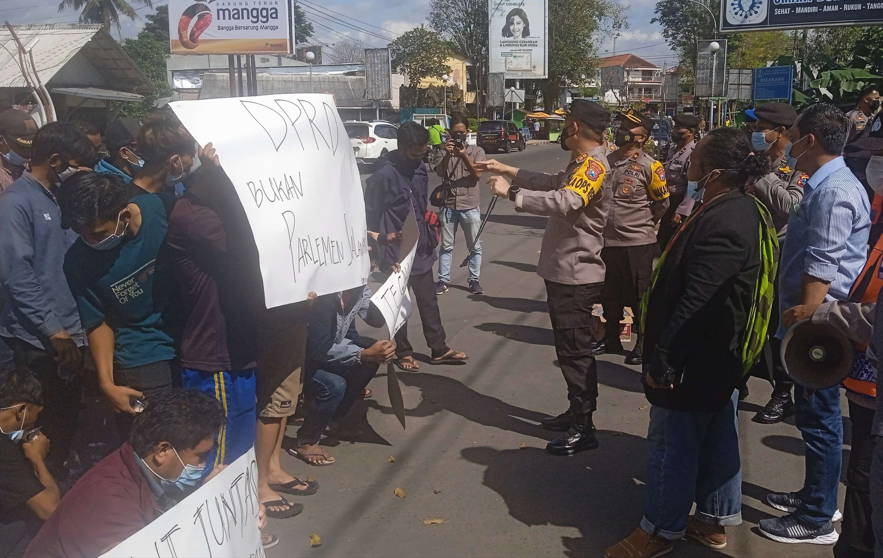 Puluhan relawan Bupati Bondowoso Salwa Arifin demo di depan Mapolres setempat ditemui Kapolres Bondowoso AKBP Wimboko. (Foto: Guido Saphan/Ngopibareng.id)
