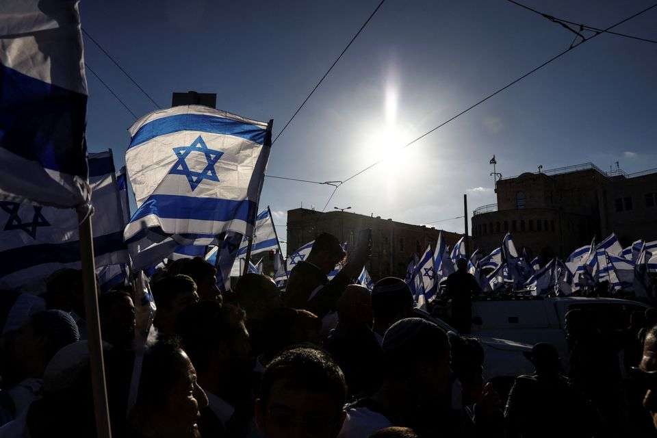 Demonstran sayap kanan Israel meneriakkan slogan-slogan sambil membawa bendera nasional selama protes di Yerusalem 20 April 2022. (Foto: Reuters)