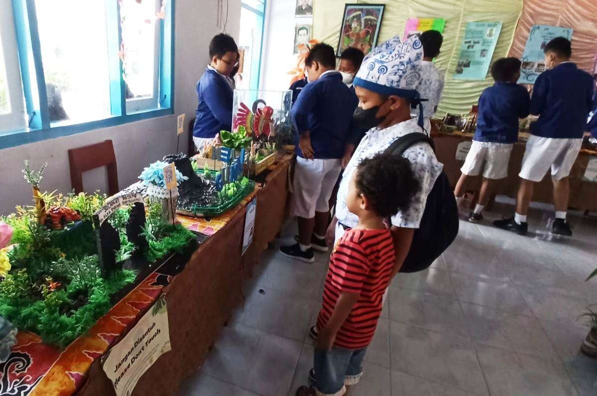 Beberapa murid SD tampak bersemangat melihat pameran hasil kreativitas muri SD se-Kecamatan Giri, Banyuwangi, Jawa Timur. (Foto: Muh Hujaini/Ngopibareng.id)