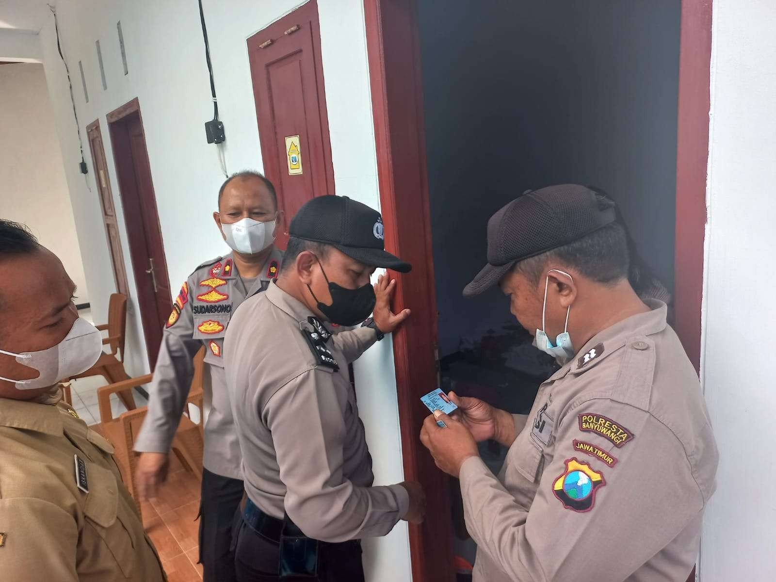 Petugas memeriksa identitas salah satu penghuni rumah kos di Banyuwangi. (Foto: Istimewa)