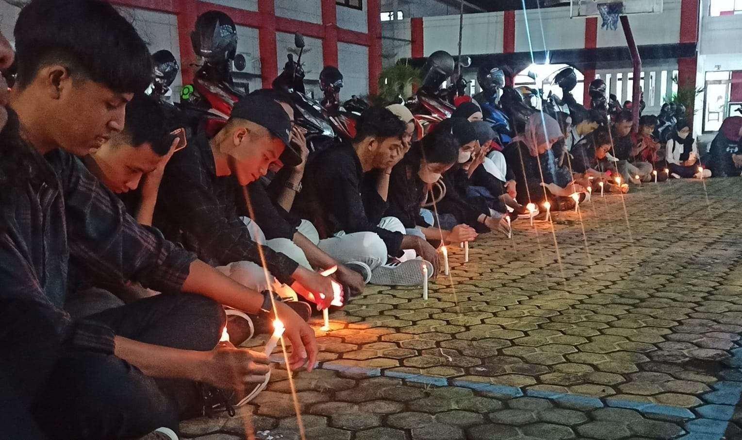 Sejumlah Mahasiswa Untag Banyuwangi melakukan aksi solidaritas dengan mengelar doa bersama untuk Aremania yang meninggal di Kanjuruhan (Foto: Muh Hujaini/Ngopibareng.id)