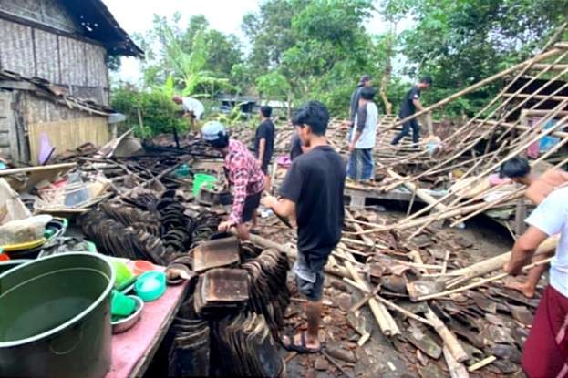 Warga Desa Jebung Lor Tlogosari Bondowoso membersihkan reruntuhan bangunan rumah milik Maimunah yang ambruk rata dengan tanah. (Foto: Guido Saphan/Ngopibareng.id)