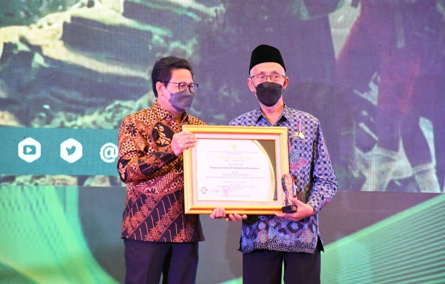 Mendes PDTT RI Halim Iskandar menyerahkan penghargaan kepada Bupati Bondowoso, Salwa Arifin. (Foto: Diskominfo Bondowoso)