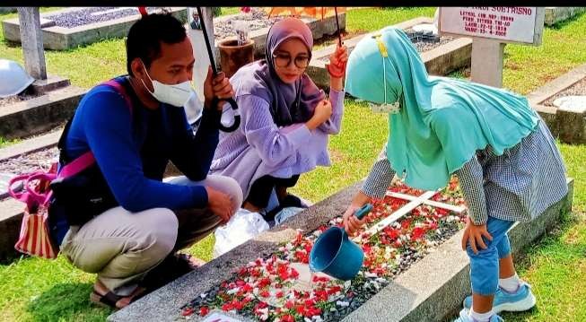Ziarah ke makam orang tua menjadi tradisi menjelang puasa Ramadan, tampak peziarah khusuk berdoa untuk keluarga di TMP Nasional Kalibata; Jakarta Selatan (Foto: Asmanu Sudharso/ngopibareng.id)