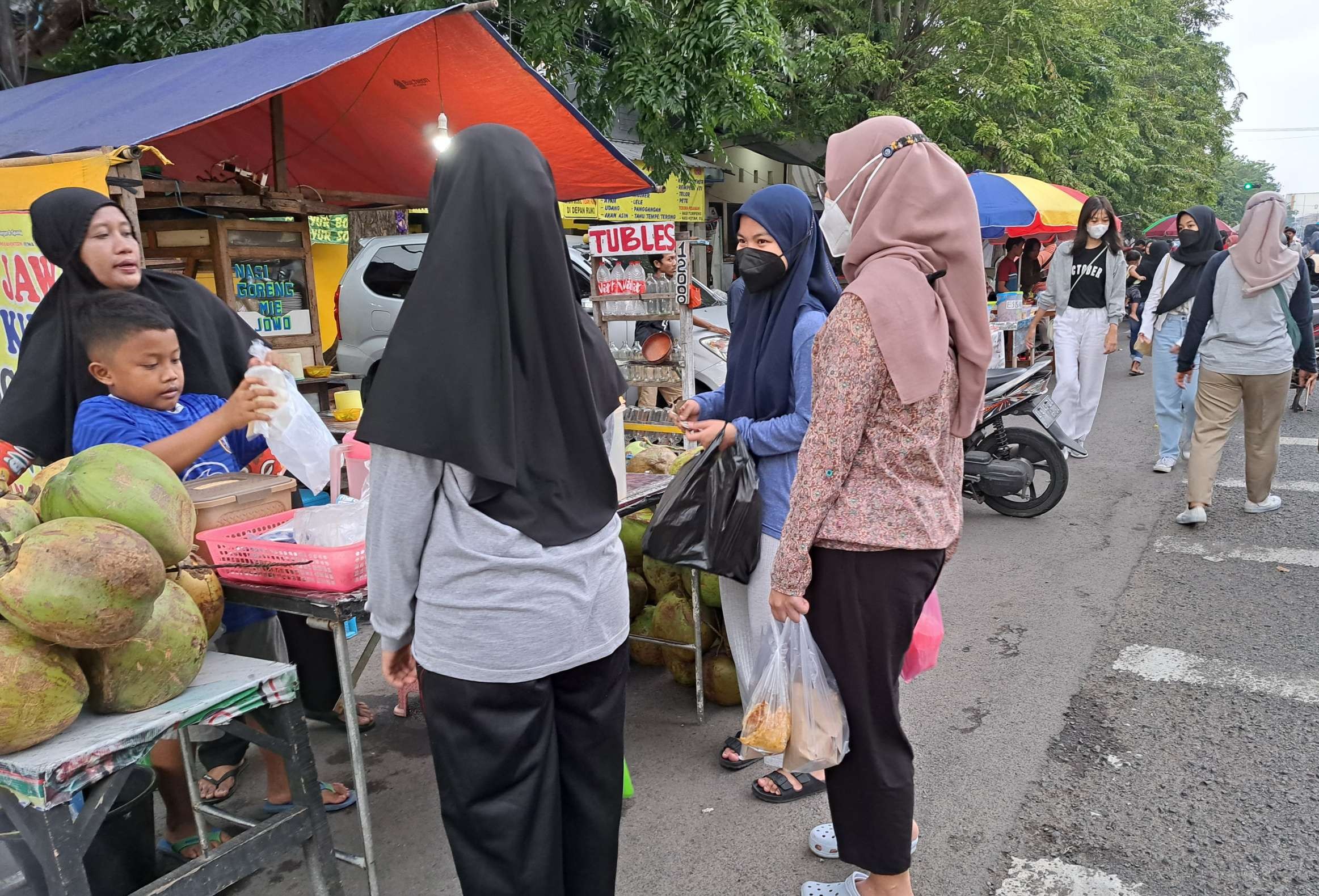 Suasana pasar Ramadan di kawasan Karang Menjangan, Surabaya, yang masih banyak menggunakan kantong plastik sebagai pembungkus makanan dan minuman. (Foto: Pita Sari/Ngopibareng.id)