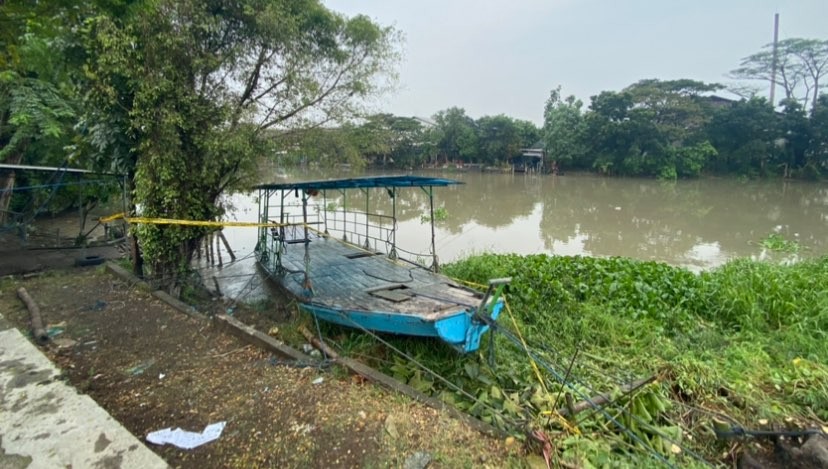 Perahu tambang yang tenggelam di sungai kawasan Jalan Raya Mastrip, Karangpilang, Surabaya, Sabtu, 25 Maret 2023, belum dievakuasi petugas. (Foto: Andhi Dwi/Ngopibareng.id)