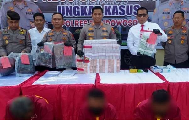 Kapolres Bondowoso, AKBP Bimo Ariyanto menunjukkan barang bukti uang Rp 217 juta dan tiga pelaku penipuan penukaran uang di Mapolres Bondowoso, Senin 5 Juni 2023.(foto:guido/ngopibareng.id)