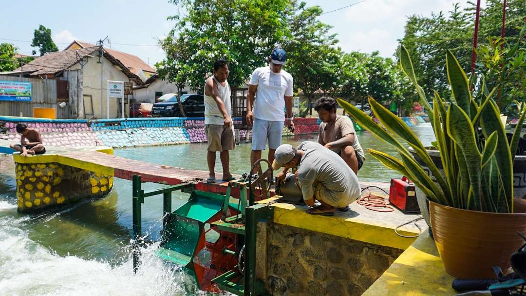 Kincir air di sungai Pelayaran Desa Penambangan, Sidoarjo jadi Sumber Tenaga Listrik. (Foto: Aini Arifin/Ngopibareng.id)