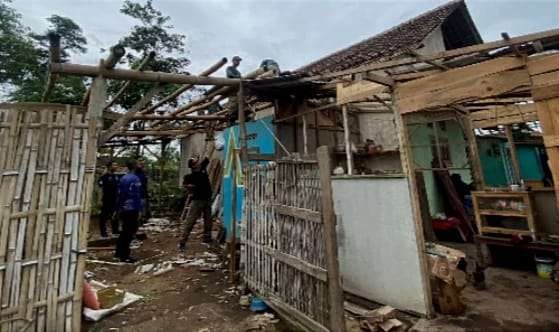 Anggota TNI, Polri, BPBD, dan warga membersihkan reruntuhan atap rumah akibat terjangan puting beliung di Kecamatan Prajekan Bondowoso. (Foto: BPBD Bondowoso)