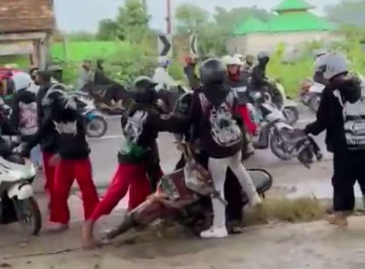 Tangkapan layar dari video viral pengeroyokan pengendara motor oleh rombongan oknum dari salah satu pencak silat di Tuban, Jawa Timur. (Foto: Istimewa)