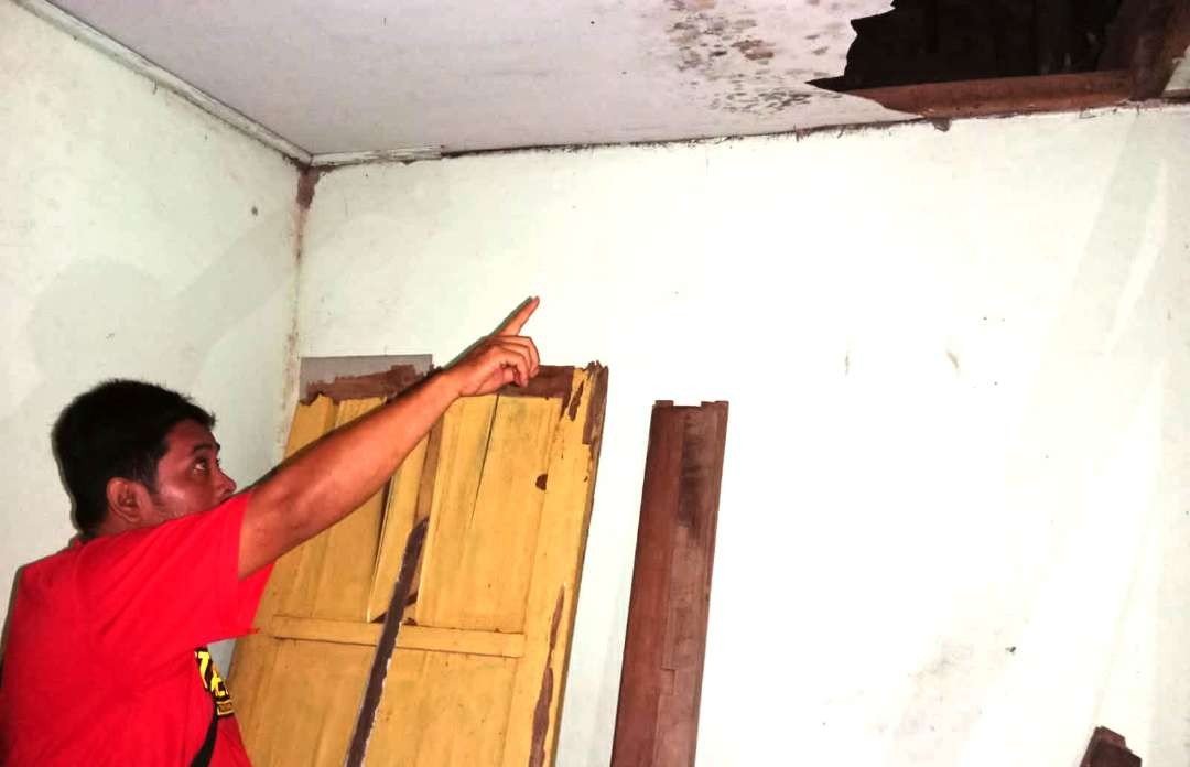 Petugas Polsek Menunjukkan lubang pada plafon rumah korban (Foto: istimewa)