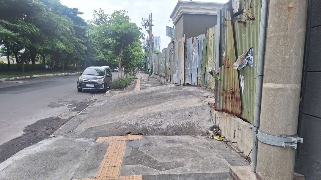 Persil salah satu rumah di kawasan Jalan Kertajaya Indah, Kertajaya, Surabaya, yang menutupi pedestrian dan tanda untuk pejalan kaki disabilitas, Selasa 12 Maret 2024. (Foto: Julianus Palermo/Ngopibareng.id)